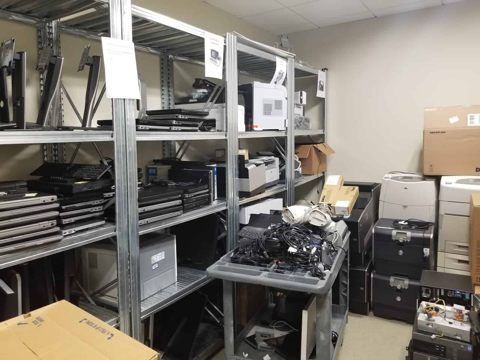 A room full of computers, printers, and other equipment.